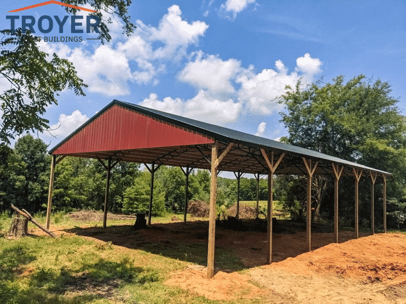 red hay barn for sale on dirt in countryside