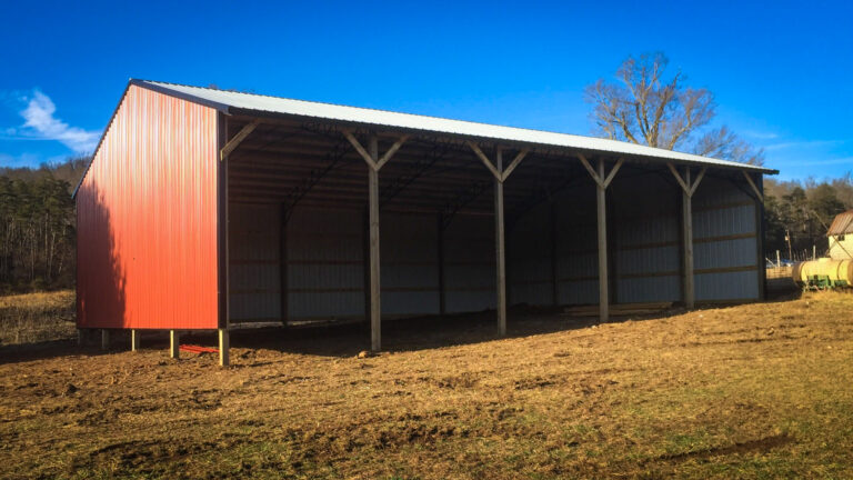 pole barn equipment shed red with blue sky