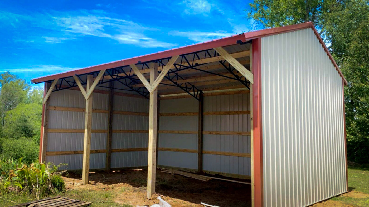 pole barn equipment shed white with red trim